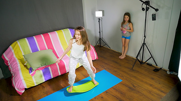 Teen girl having fun indoor surfing